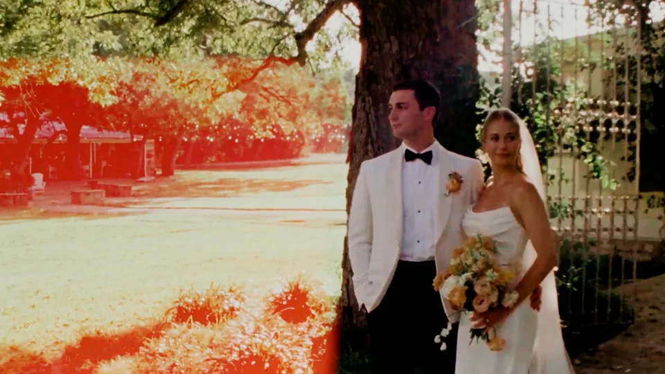 Super 8 film frame of a bride and groom under a big tree at Pecan Springs Ranch