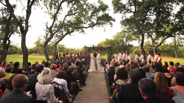 Guests seated beneath the oaks for an outdoor ceremony at Vista West Ranch