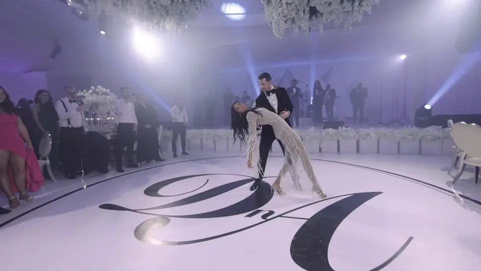 Adam dips Daniela on a white dance floor with their DA monogram at Amanera, a still from the Film of the Year winning wedding film