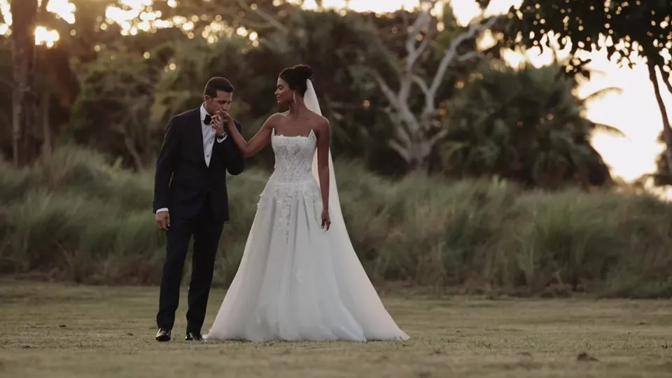 Daniela and Adam in a golden field at Amanera, Dominican Republic, a still from Adam Grumbo's film of their wedding